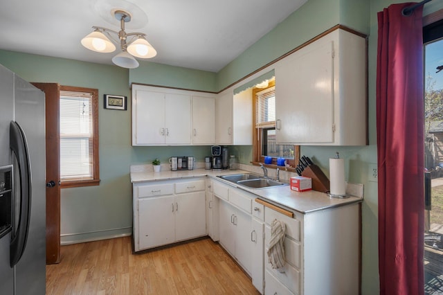 5748 25th Ave S, Minneapolis, MN 55417 - kitchen featuring stainless steel fridge with ice dispenser, light countertops, light wood finished floors, and plenty of natural light