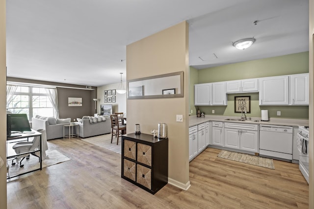 2803 38th St Unit 205, Minneapolis, MN 55406 - kitchen with dishwasher, a sink, light wood-style floors, white cabinetry, and light countertops