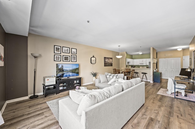2803 38th St Unit 205, Minneapolis, MN 55406 - living room featuring wood finished floors and baseboards