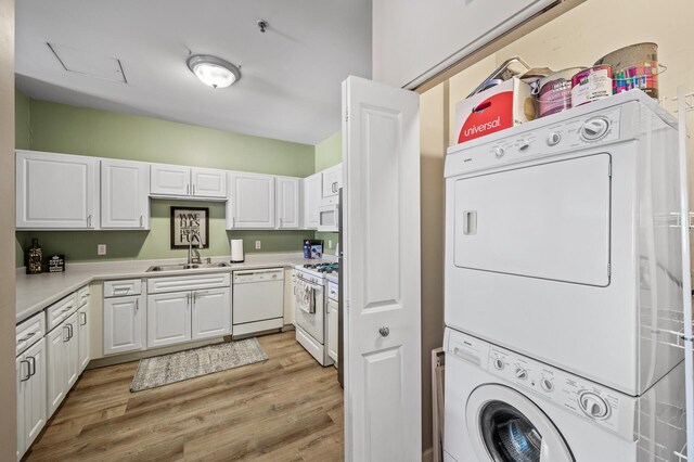 2803 38th St Unit 205, Minneapolis, MN 55406 - clothes washing area featuring stacked washer / drying machine and light wood finished floors