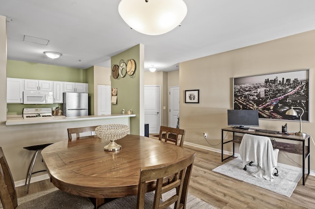 2803 38th St Unit 205, Minneapolis, MN 55406 - dining space with light wood-style floors, baseboards, and a desk