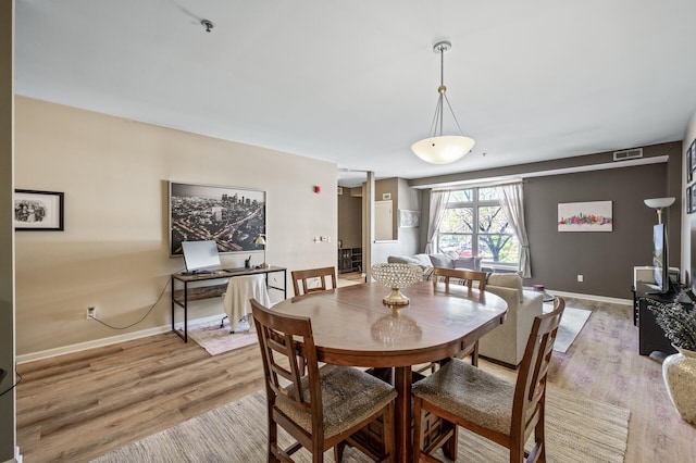 2803 38th St Unit 205, Minneapolis, MN 55406 - dining room with light wood-style floors and baseboards