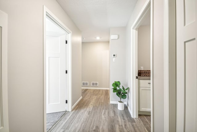20074 Fitzgerald Trl N, Forest Lake, MN 55025 - hallway featuring light wood-style floors, baseboards, and recessed lighting