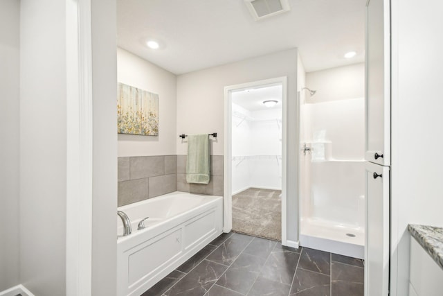 20074 Fitzgerald Trl N, Forest Lake, MN 55025 - bathroom with a walk in shower, marble look tile flooring, a walk in closet, a garden tub, and recessed lighting