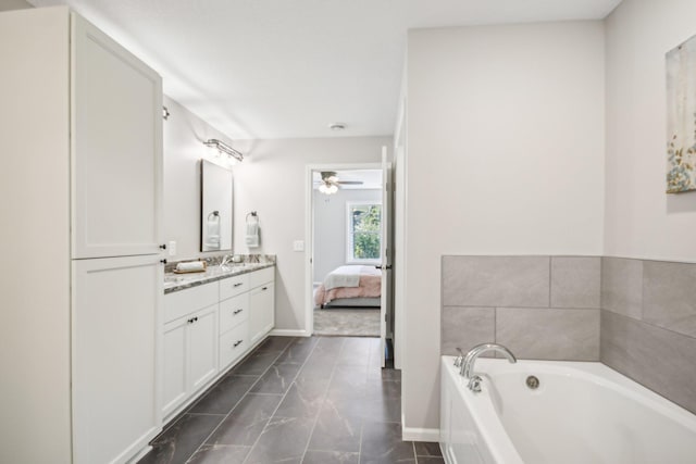 20074 Fitzgerald Trl N, Forest Lake, MN 55025 - ensuite bathroom with a garden tub, marble finish flooring, vanity, ceiling fan, and baseboards