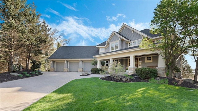 6470 Tanagers Pt, Chanhassen, MN 55331 - craftsman-style home with driveway, stone siding, covered porch, a front yard, and an attached garage