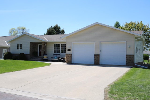 single story home with brick siding, an attached garage, driveway, and a front yard