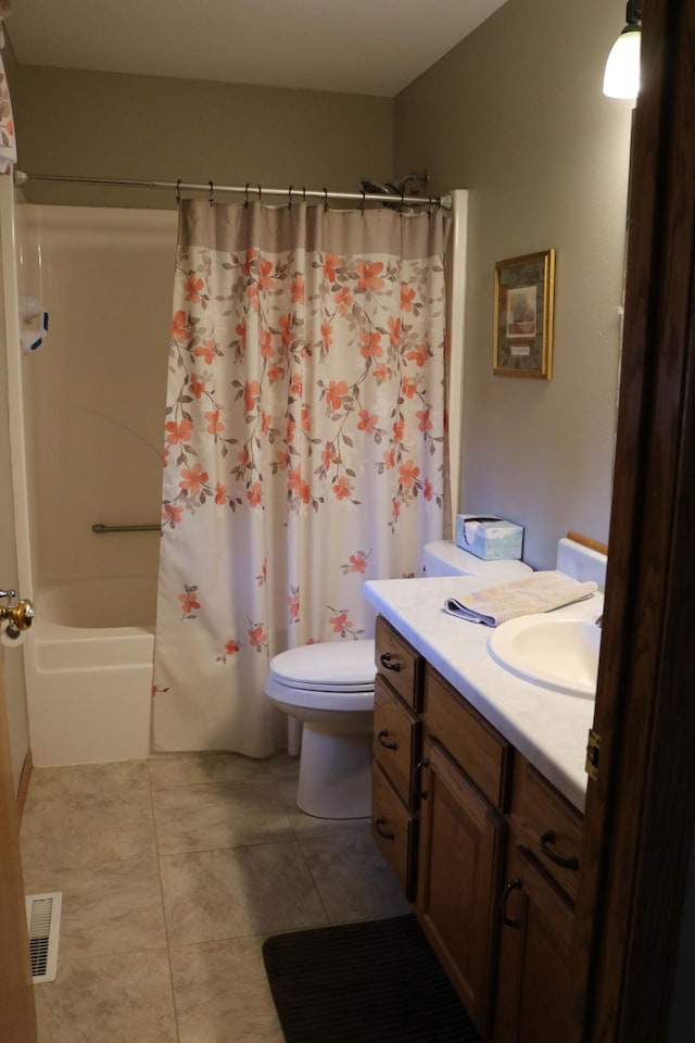 full bathroom with tile patterned flooring, toilet, vanity, and shower / bath combo