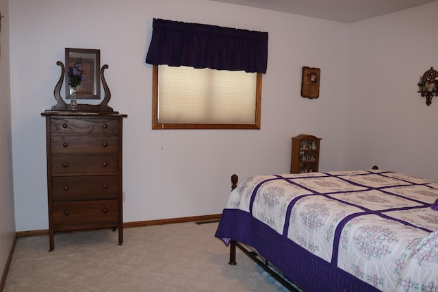bedroom featuring carpet and baseboards