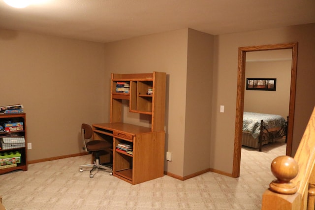 carpeted office space featuring baseboards