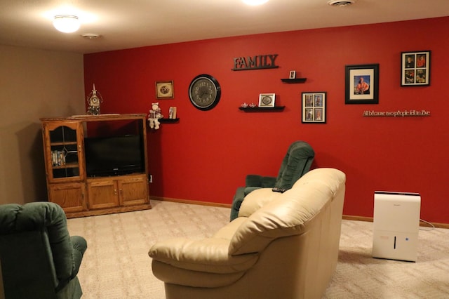carpeted living area with baseboards