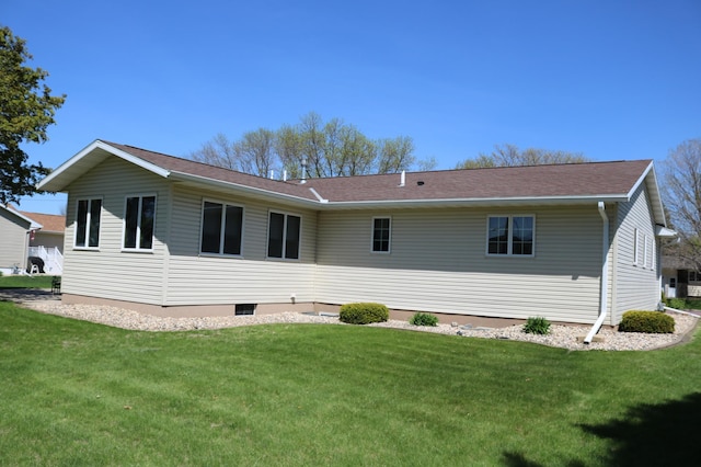 rear view of property with a lawn