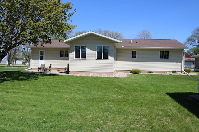 back of property featuring a yard and a patio area