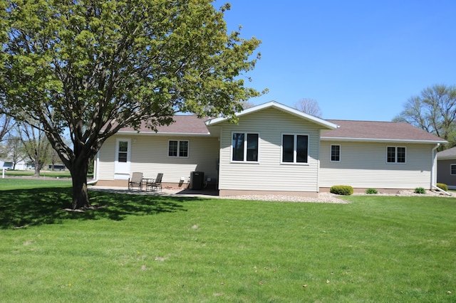 back of house with a yard, central AC unit, and a patio