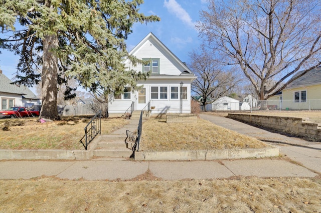 bungalow-style house featuring fence and entry steps