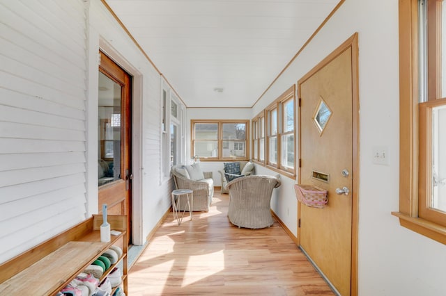 sunroom / solarium featuring wood finished floors and baseboards