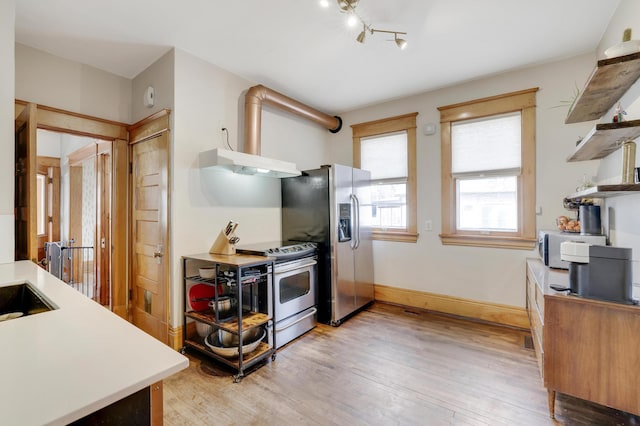 kitchen with appliances with stainless steel finishes, open shelves, light wood-style floors, light countertops, and under cabinet range hood