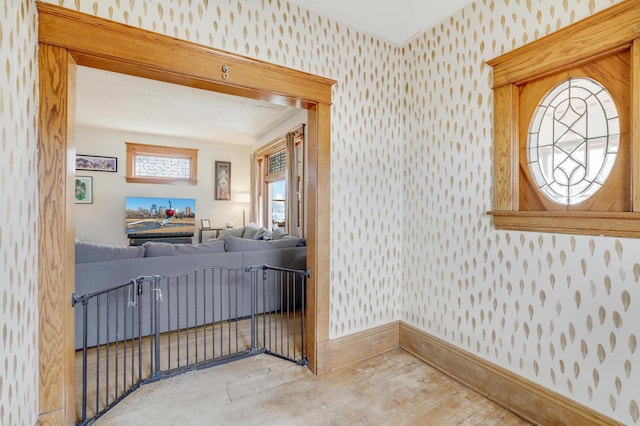 entryway with wallpapered walls and baseboards