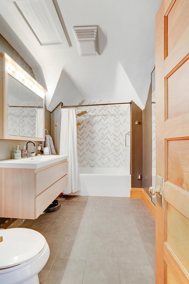 full bath with shower / tub combo with curtain, vaulted ceiling, tile patterned flooring, vanity, and toilet