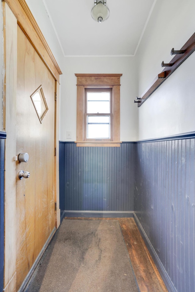 doorway to outside featuring wainscoting