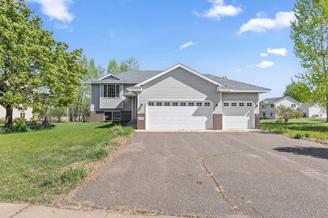 7724 385th St, North Branch, MN 55056 - view of front of home with brick siding, a garage, a front lawn, driveway, and roof with shingles