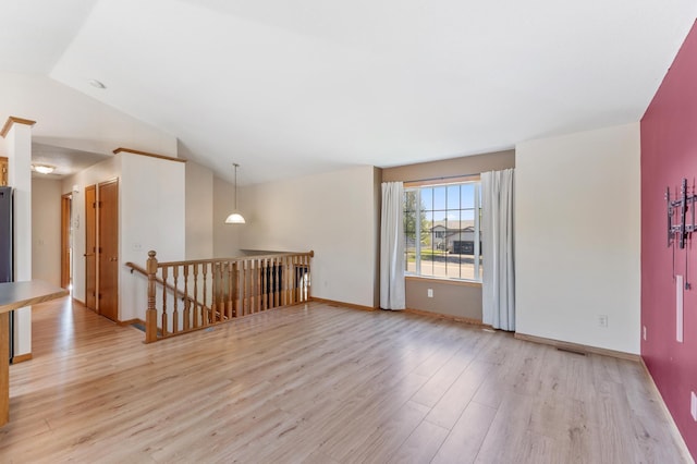 7724 385th St, North Branch, MN 55056 - spare room with vaulted ceiling, light wood-style floors, and baseboards