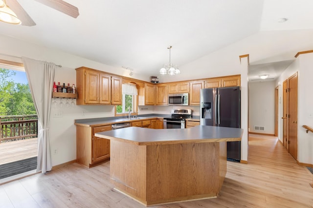 7724 385th St, North Branch, MN 55056 - kitchen with appliances with stainless steel finishes, lofted ceiling, light wood-style flooring, a chandelier, and a center island