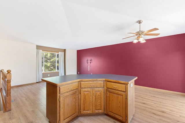 7724 385th St, North Branch, MN 55056 - kitchen featuring light wood-style flooring, ceiling fan, a center island, and brown cabinets
