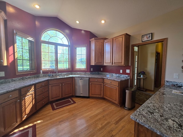 1073 Harvest Way, Lake City, MN 55041 - kitchen with stainless steel dishwasher, light wood-style flooring, vaulted ceiling, brown cabinetry, and a sink