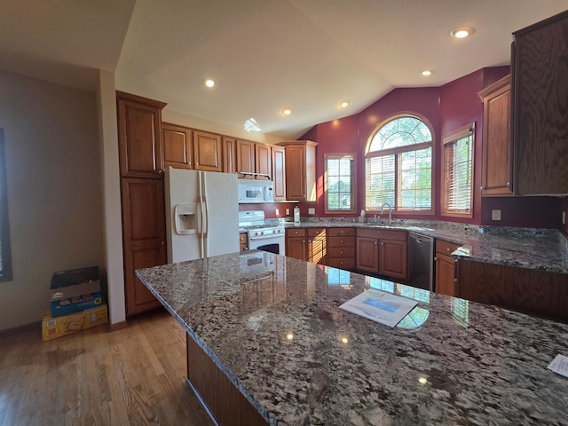 1073 Harvest Way, Lake City, MN 55041 - kitchen featuring white appliances, light wood-type flooring, dark stone countertops, vaulted ceiling, and recessed lighting