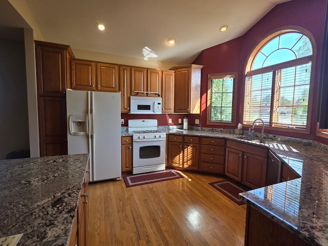 1073 Harvest Way, Lake City, MN 55041 - kitchen featuring white appliances, vaulted ceiling, light wood-style flooring, recessed lighting, and dark stone countertops