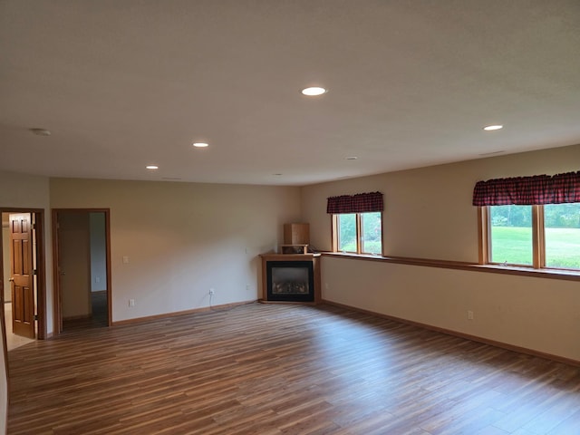 1073 Harvest Way, Lake City, MN 55041 - unfurnished living room featuring wood finished floors, a glass covered fireplace, and recessed lighting