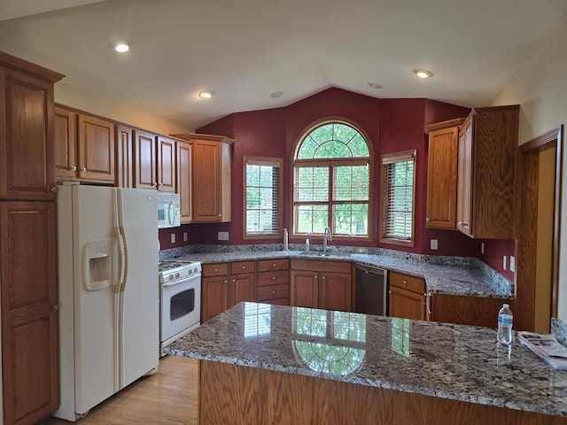 1073 Harvest Way, Lake City, MN 55041 - kitchen featuring white appliances, lofted ceiling, brown cabinetry, and recessed lighting