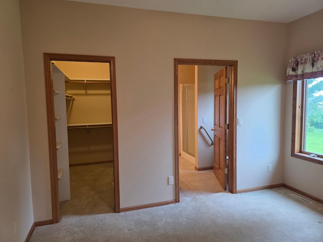 1073 Harvest Way, Lake City, MN 55041 - unfurnished bedroom featuring carpet, a walk in closet, and a closet