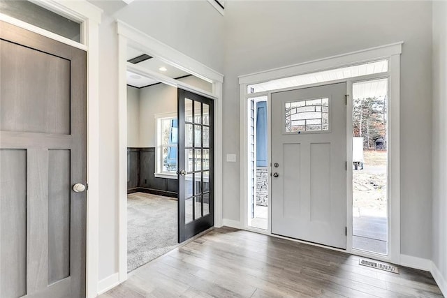 foyer entrance with wood finished floors and baseboards