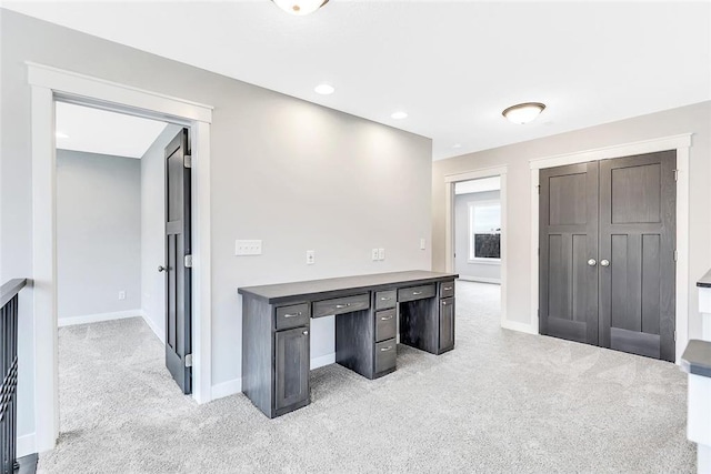 unfurnished office with light colored carpet and baseboards