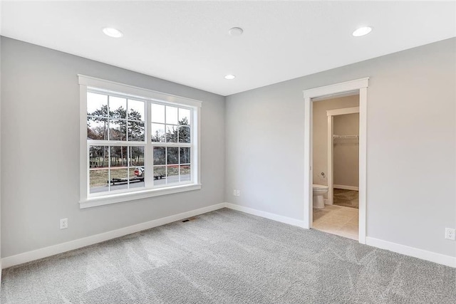 unfurnished bedroom featuring carpet, recessed lighting, and baseboards