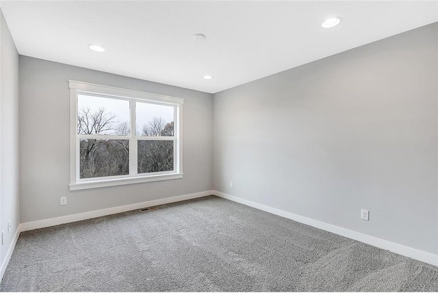 empty room with carpet floors, baseboards, and recessed lighting