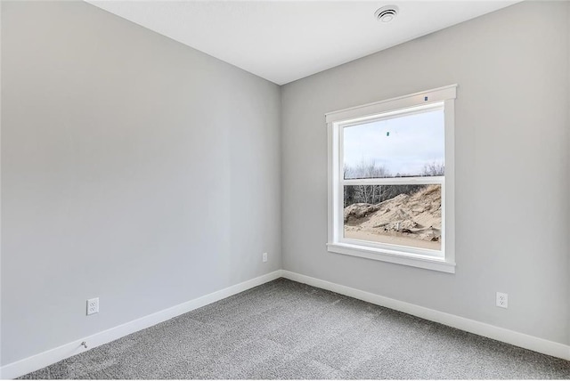 carpeted spare room with baseboards