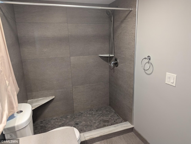 full bathroom with toilet and tiled shower