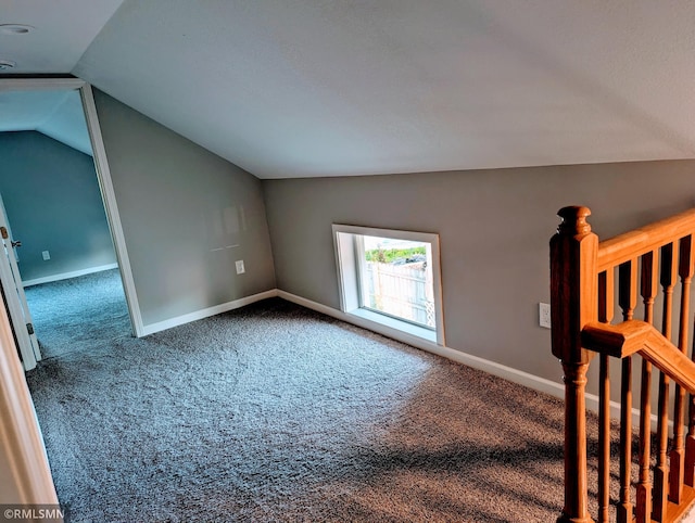 bonus room with lofted ceiling, carpet flooring, and baseboards