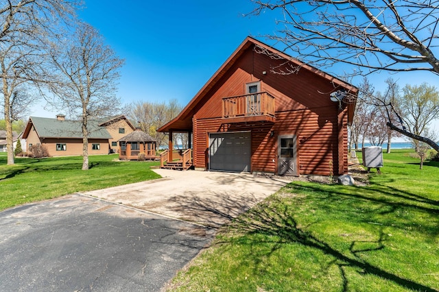 37009 Blarney Beach Rd, Everts Twp, MN 56515 - chalet / cabin featuring driveway, a garage, a front lawn, log exterior, and a balcony