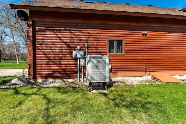 37009 Blarney Beach Rd, Everts Twp, MN 56515 - rear view of house with central AC unit, a yard, a shingled roof, and log siding
