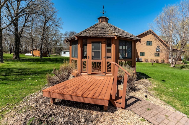 37009 Blarney Beach Rd, Everts Twp, MN 56515 - wooden deck featuring a lawn, an outbuilding, and a gazebo