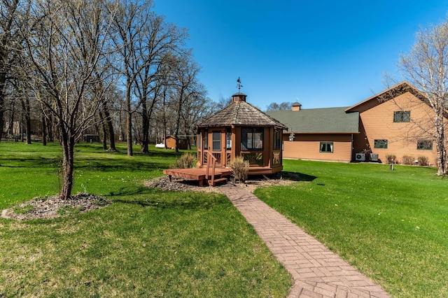 37009 Blarney Beach Rd, Everts Twp, MN 56515 - back of house featuring a gazebo, a chimney, a yard, an outdoor structure, and a storage shed