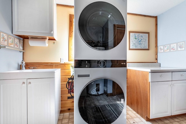 37009 Blarney Beach Rd, Everts Twp, MN 56515 - laundry area with stacked washer / drying machine, cabinet space, and light floors