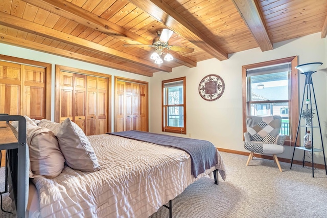 37009 Blarney Beach Rd, Everts Twp, MN 56515 - carpeted bedroom with beamed ceiling, wood ceiling, two closets, baseboards, and a ceiling fan