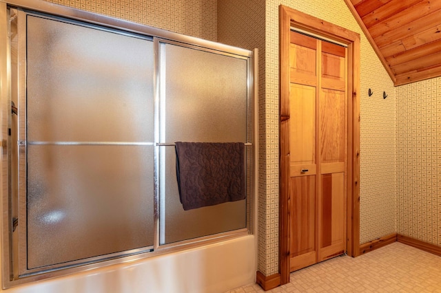 37009 Blarney Beach Rd, Everts Twp, MN 56515 - bathroom featuring lofted ceiling, wood ceiling, bath / shower combo with glass door, baseboards, and wallpapered walls