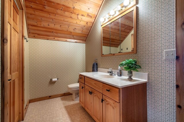 37009 Blarney Beach Rd, Everts Twp, MN 56515 - bathroom featuring vaulted ceiling, wooden ceiling, toilet, vanity, and wallpapered walls