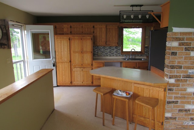 29618 110th Pl, Sturgeon Lake, MN 55783 - kitchen featuring freestanding refrigerator, a sink, a kitchen bar, tasteful backsplash, and butcher block counters